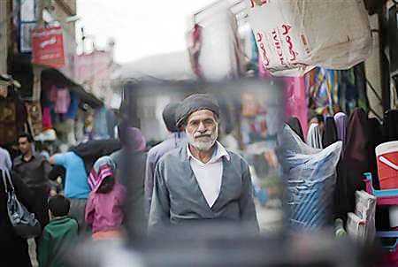 An Iranian Sunni Kurd walks at a bazaar while shopping in Marivan in Kurdistan province