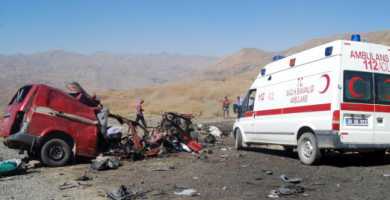 People stand near a damaged vehicle after a landmine blew up a minibus in Turkey’s Hakkari province Sept. 16 STR/AFP/Getty Images