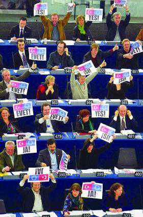 Members of the European Parliament hold placards reading 'Yes' on Dec. 15, 2004 during a vote on a resolution asking EU members to open talks with Turkey immediately. Members of the European Parliament hold placards reading 'Yes' on Dec. 15, 2004 during a vote on a resolution asking EU members to open talks with Turkey immediately.