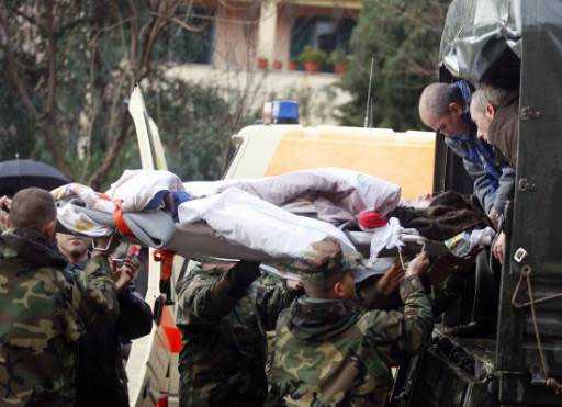 (Army forces evacuate a person from the flooded area of Shkoder, some 100 km (62 miles) north of the capital Tirana.) 