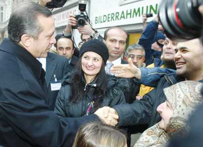 This file photo shows Turkish Prime Minister Recep Tayyip Erdoğan shaking hands with Turkish residents of Berlin's Kreuzberg district in 2004. AP photo