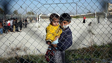 Greek Plan to Build Border Fence Draws Fire in Turkey  Angelos Tzortzinis, AFP / Getty Images  Immigrant children peer out through the fence of an immigrant detention center in the village of Filakio, on the Greek-Turkish border.