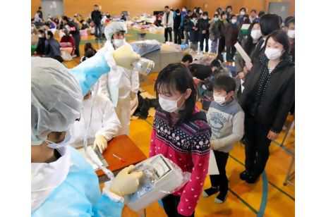 Japanese medical personnel check a child for radiation exposure in Fukushima. Turkish officials say that what happened at Japan's nuclear facilities will not stop the nation's plant to build power plants.  Asahi Shimbun / EPA