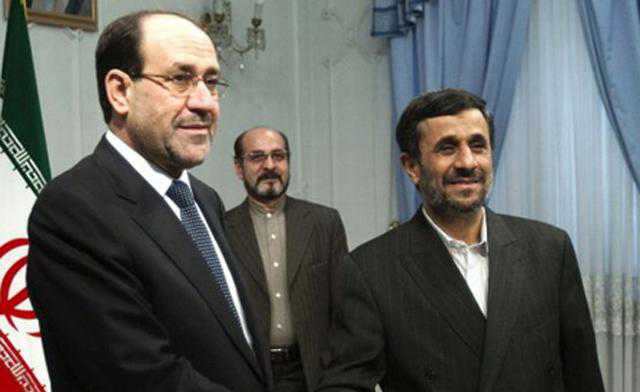Iran's president Mahmoud Ahmadinejad (R) shakes hands with Iraq's prime minister Nouri Al-Maliki during an official meeting in Tehran. (File Photo)