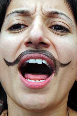 woman_moustache AFP/Getty Images A Turkish woman with drawn moustache chants slogans during a 2009 protest.
