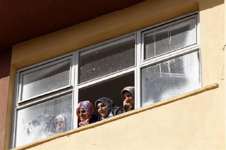 Women watch a campaign event from a window in Kozluk, a town in the southeast province of Batman, April 21, 2011. Credit: Reuters/Umit Bektas