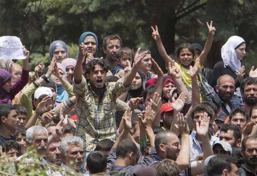 Syrians protest the regime in Turkey while others show their support in Damascus