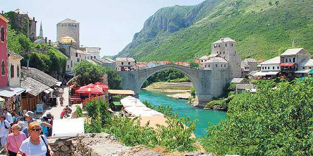 Tourists walk through the center of the old town of Mostar in the south of Bosnia and Herzegovina. The city of Mostar, with its old town and bridge originally built under the Ottoman Empire, attracts more and more Turkish tourists.