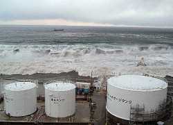 In this March 11, 2011 file photo released by Tokyo Electric Power Co., waves of tsunami come toward tanks of heavy oil for the Unit 5 of the Fukushima Dai-ichi nuclear complex in Okuma, Fukushima Prefecture, northeastern Japan. (AP Photo/Tokyo Electric Power Co.)