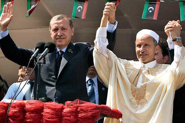 Turkey's Prime Minister Tayyip Erdogan (l.) and Chairman of Libya's National Transitional Council Mustafa Abdel Jalil wave to people during a rally at Martyrs' Square in Tripoli on Friday, Sept. 16.  Suhaib Salem/Reuters