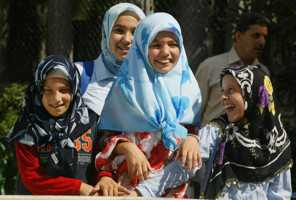 Girls wearing Islamic headscarves play in a park in Istanbul. (Osman Orsal/AP) 