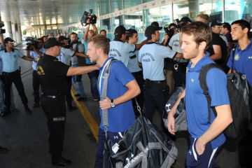 Turkish riot police stand guard as Maccabi Tel-Aviv players walk towards a bus at Ataturk Airport in Istanbul, on Sept. 14, 2011. (Bulent Kilic/AFP/Getty Images)