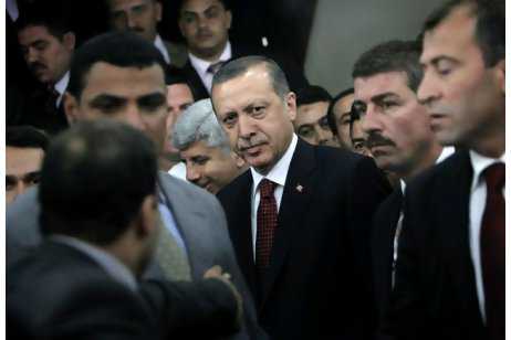 turkishprimem Turkish prime minister Recep Tayyip Erdogan, centre, surrounded by his bodyguards, leaves after his meeting with Grand Sheik of Al Azhar Ahmed el Tayyib in Cairo yesterday. Nasser Nasser / AP Photo