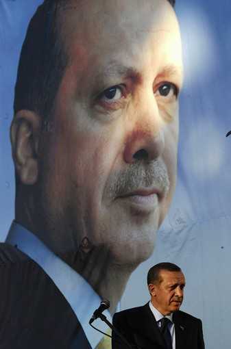 Turkish Prime Minister Recep Tayyip Erdogan speaks under a portrait of himself in Gostivar, Macedonia. (Ognen Teofilovski, Reuters / October 11, 2011)