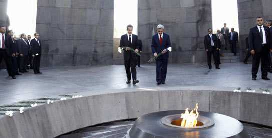 French President Nicolas Sarkozy, left, and Armenian President Serge Sarkisian lay flowers at the Armenian Genocide Memorial in Yerevan, Armenia. -AP Photo