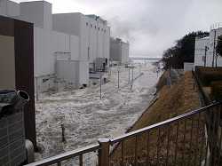 In this March 11, 2011 photo released Monday, April 11, 2011 by Tokyo Electric Power Co.,(TEPCO), the access road at the compound of the Fukushima Dai-ichi nuclear power plant is flooded as tsunami hit the facility following a massive earthquake in Okuma town, Fukushima Prefecture, northeastern Japan. (AP Photo/Tokyo Electric Power Co.,)