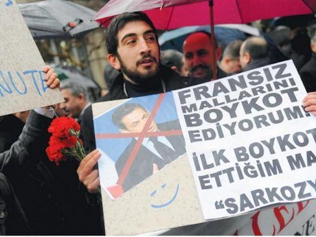 5917002 A man holds a placard reading "I boycott French goods" during a demonstration in front of the French consulate in Istanbul to protest a new law in France outlawing denial of the 1915 Armenian genocide in Ottoman Turkey.