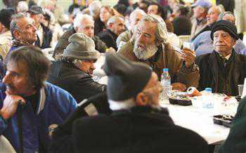 Homeless people sit at tables during a New Year’s meal in Athens Jan 1. Greek jobseekers are looking for work in cities like Istanbul. This happens during hard times, like the emigration process after the World War II, says Triantaphyllou. REUTERS photo 