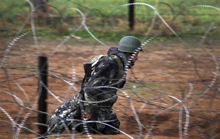 Turkish soldier takes up his position near the border with Syria as seen from the Turkish border town of Ceylanpinar