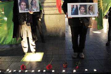 FREDERICK FLORIN / AFP / Getty Images People attending a demonstration in Strasbourg, France, on Jan. 10, 2013, hold photos of three Kurdish activists killed in Paris Read more: