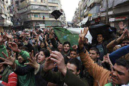 Demonstrators chant slogans and wave Syrian opposition flags during a protest against Syria's President Bashar al-Assad in Aleppo