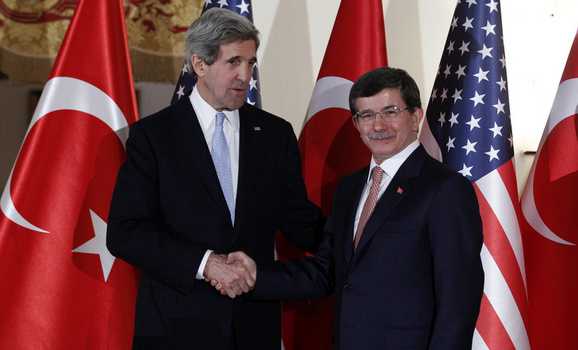 U.S. Secretary of State Kerry shakes hands with Turkish FM Davutoglu at Ankara Palas in Ankara