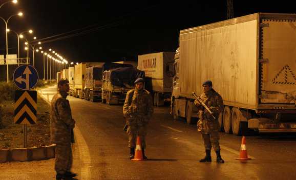 Turkish soldiers block a road to Cilvegozu border gate near the town of Reyhanli on the Turkish-Syrian border in Hatay province