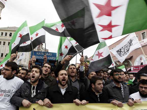 Demonstrators shout slogans during a protest against the government of Syria's President Bashar al-Assad, in Istanbul