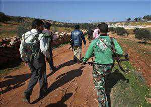 Free Syrian Army fighters from the Knights of the North brigade move to reconnaissance a Syrian army forces base of al-Karmid, at Jabal al-Zaweya, in Idlib province, Syria, Wednesday, Feb. 27, 2013. Syrian...   (Associated Press)