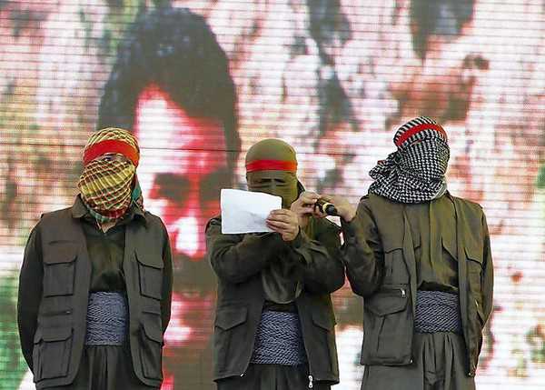 Masked supporters of jailed Kurdish rebel leader Abdullah Ocalan stand on the stage as one reads a statement during a gathering to celebrate Newroz in the southeastern Turkish city of Diyarbakir (Umit Bektas Reuters, / March 21, 2013)