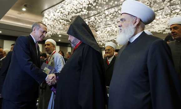 Turkey's Prime Minister Erdogan shakes hands with Archbishop Manougian, Patriarchal Vicar of the Armenian Patriarchate of Jerusalem, in Istanbul