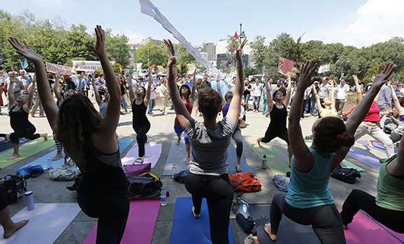 People practice yoga in Gezi Park at Taksim Square in Istanbul, June 7, 2013. (photo by REUTERS/Osman Orsal) Read more: http://www.al-monitor.com/pulse/originals/2013/10/yoga-halal-turkey-ruling.html#ixzz2jF1MLeWp